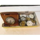 A tray of watch spares including travel clock.