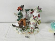 A porcelain figure group with dog and sheep, 20 cm tall.