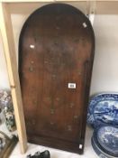A vintage leather suitcase and bagatelle board with balls