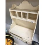 A white painted kitchen shelf