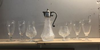 A claret jug and quantity of glasses