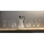 A claret jug and quantity of glasses