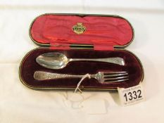 A cased silver spoon and fork, 52 grams.