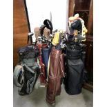 5 sets of golf clubs in bags & 1 golf bag trolley