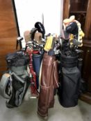 5 sets of golf clubs in bags & 1 golf bag trolley