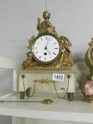 A French mantel clock on onyx base and surmounted figure. (not working).