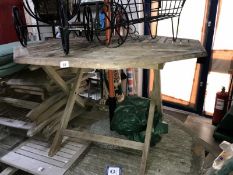 An octagonal folding garden table with 4 folding chairs,