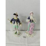 A pair of 19th century porcelain figurines with crown mark. 21cm tall.