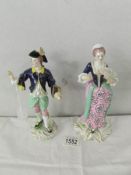 A pair of 19th century porcelain figurines with crown mark. 21cm tall.