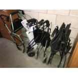 A wheelchair & 3 mobility walkers