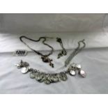 3 white metal necklaces and a bracelet.