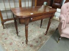 A mahogany fold over tea table.