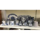 A quantity of assorted blue and white items including plates, mugs, cups and saucers etc.