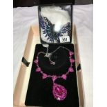 A pink stone sparkly necklace and a blue stone necklace