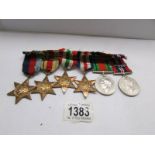 A set of 6 WW2 medals and stars with ribbons and bar including one 'Mentioned in Dispatches' bar.