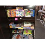 4 shelves of children's games, jigsaws & a quantity of helium balloons etc.