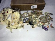 A wooden box of costume jewellery