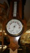 A mahogany inlaid barometer.
