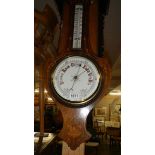 A mahogany inlaid barometer.