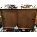 A teak sliding door cabinet