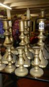 7 pairs of brass candlesticks.