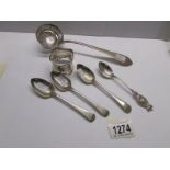 A silver sifter spoon, 4 silver teaspoons and a silver napkin ring.