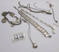 A silver bracelet, a silver cross on chain, a silver locket on chain and 4 white metal items.