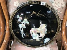 A lacquer and mother of pearl wall plaque of an oriental scene