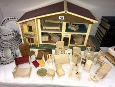 A child's toy doll house with furniture