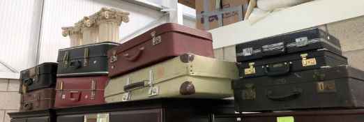 7 old suitcases and 2 brief cases