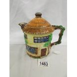 A Beswick cottage teapot.