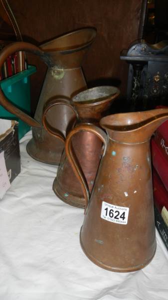 3 old copper jugs.
