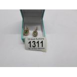 A pair of pearl and green stone pendant earrings in 15ct gold.