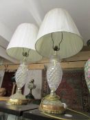 A pair of glass table lamps with shades,.