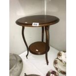 A small round tripod side table