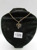 An Edwardian set pendant 9ct gold fashioned as a heart attached to a 9ct gold chain (stamped gold).