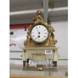 A continental gilt clock surmounted figure.