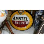 An illuminating Amstal lager advertising sign.