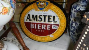 An illuminating Amstal lager advertising sign.
