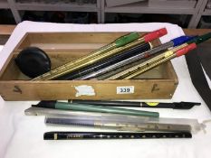 A collection of penny whistles including Tony Dixon in an old box