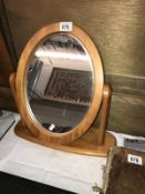 An oval wood framed mirror