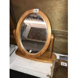 An oval wood framed mirror