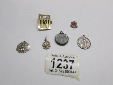 An enamelled silver threepenny bit, 2 silver St. Christopher medallions, old photo locket etc.