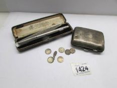 A silver cigarette case (E J Trevitt & Sons, Chester, 1918),