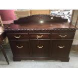 A dark wood sideboard