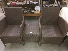 A metal framed plastic woven garden suite of 2 armchairs & a side table