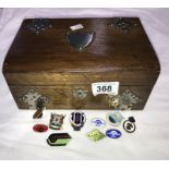 An oak trinket box with shield cartouche including pin badges