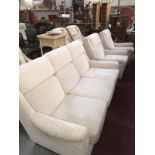 A cream coloured 3 seater sofa & 2 armchairs