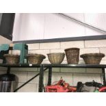 A shelf of miscellaneous including wicker baskets and a garden seat