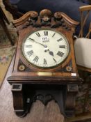 A Victorian oak cased wall clock with chain driven movement featuring presentation plaque